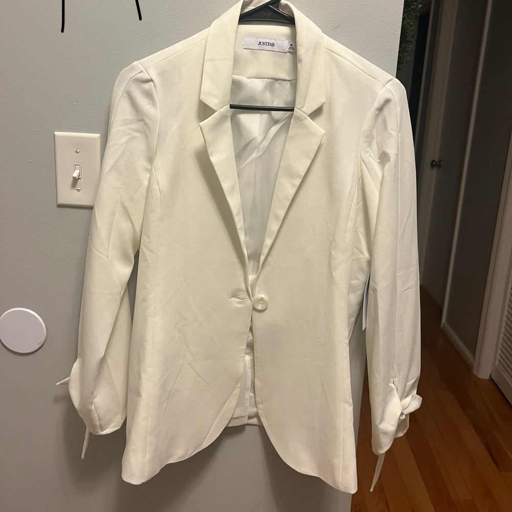 Excellent condition. Never worn. Tags on. Ribbon tie on cuffs